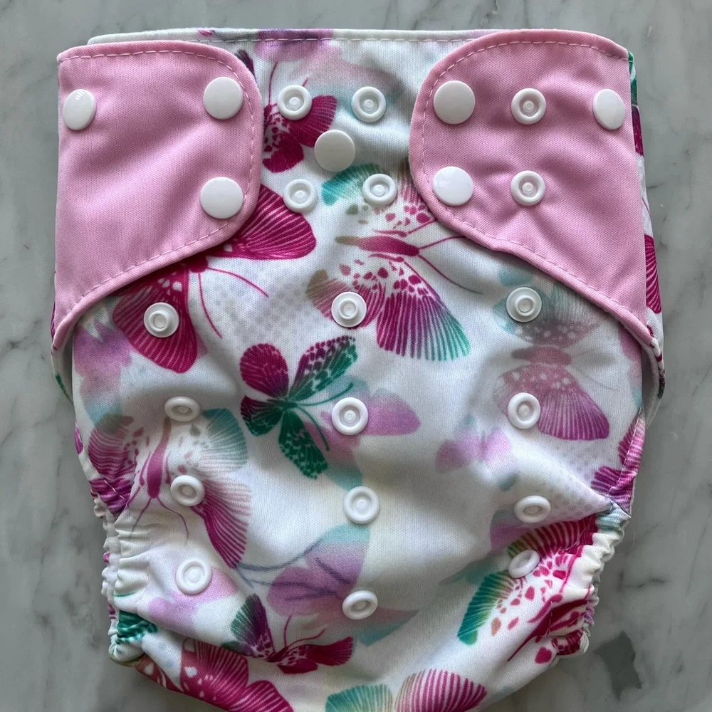 Adjustable, vinyl, disposable diapers with carry bag. Inserts bought separately.